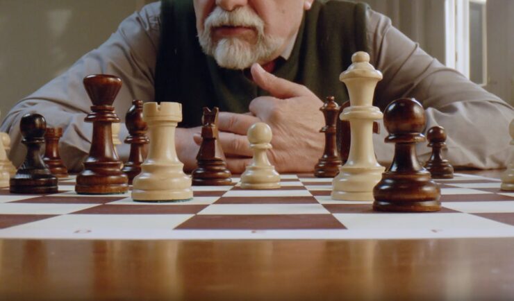 older man playing chess