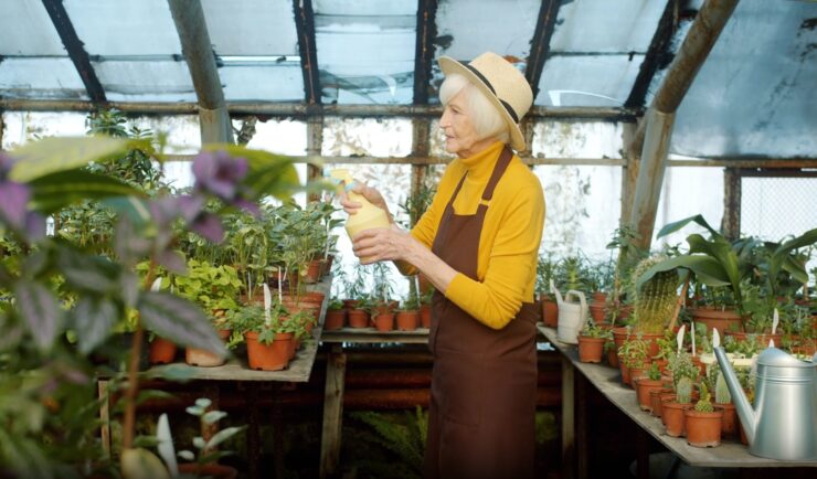 elderly woman taking care of her plants 